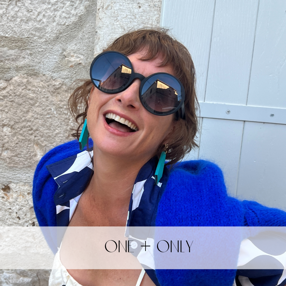 One of a kind silver necklace with three olive wood discs hanging on a womans neck