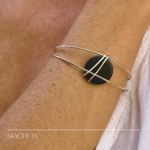 unique bracelet - gold cuff with black bead on woman's wrist