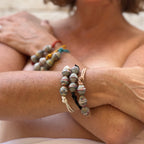 Close up photo of woman wearing recycled bracelets no shirt 