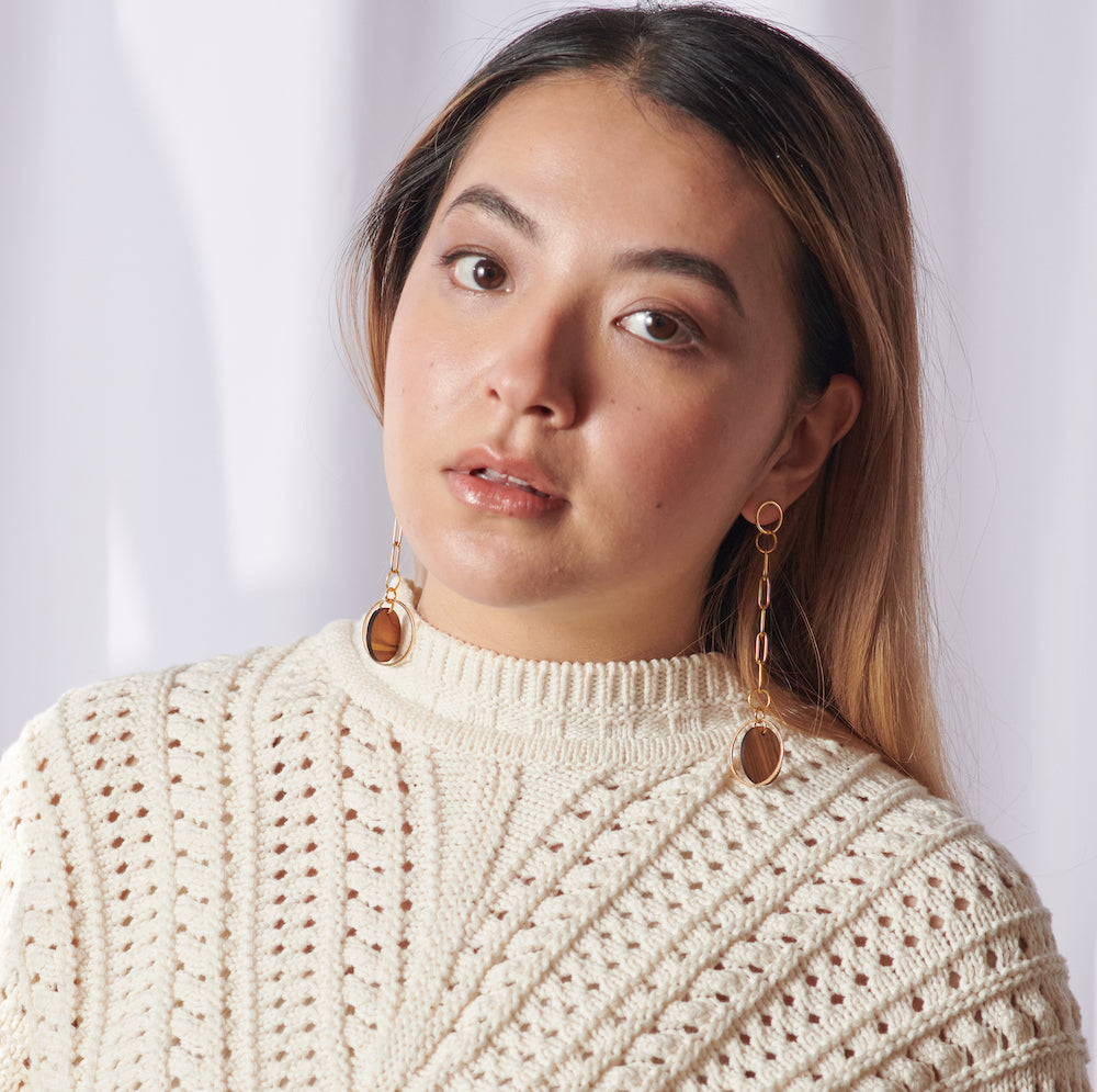 Chain link dangle earrings - wood and gold- on model in white sweater 
madera design studio