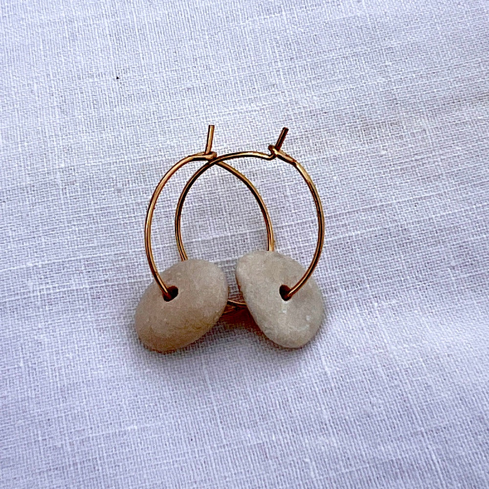 Close up shot of circle pebble hoop earrings by Justinart