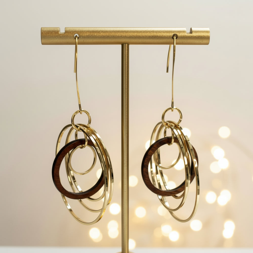 Circles Wooden and Metal Earrings by Mad Era Design Studio on a glittering background