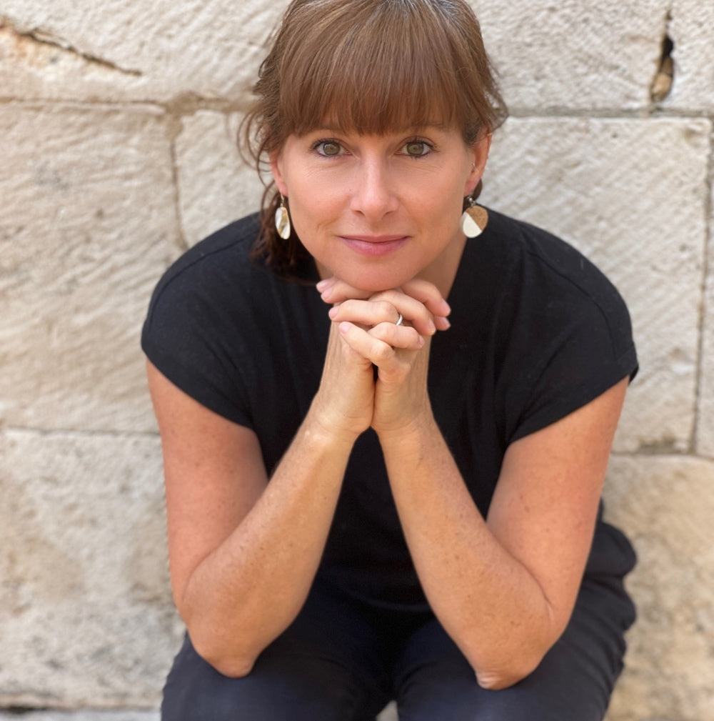 Stacey Shevlin wearing white half circle cork earrings by Justinart