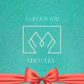 Image of a gift card in blue with an orange bow it says a gift for you Mad Era 