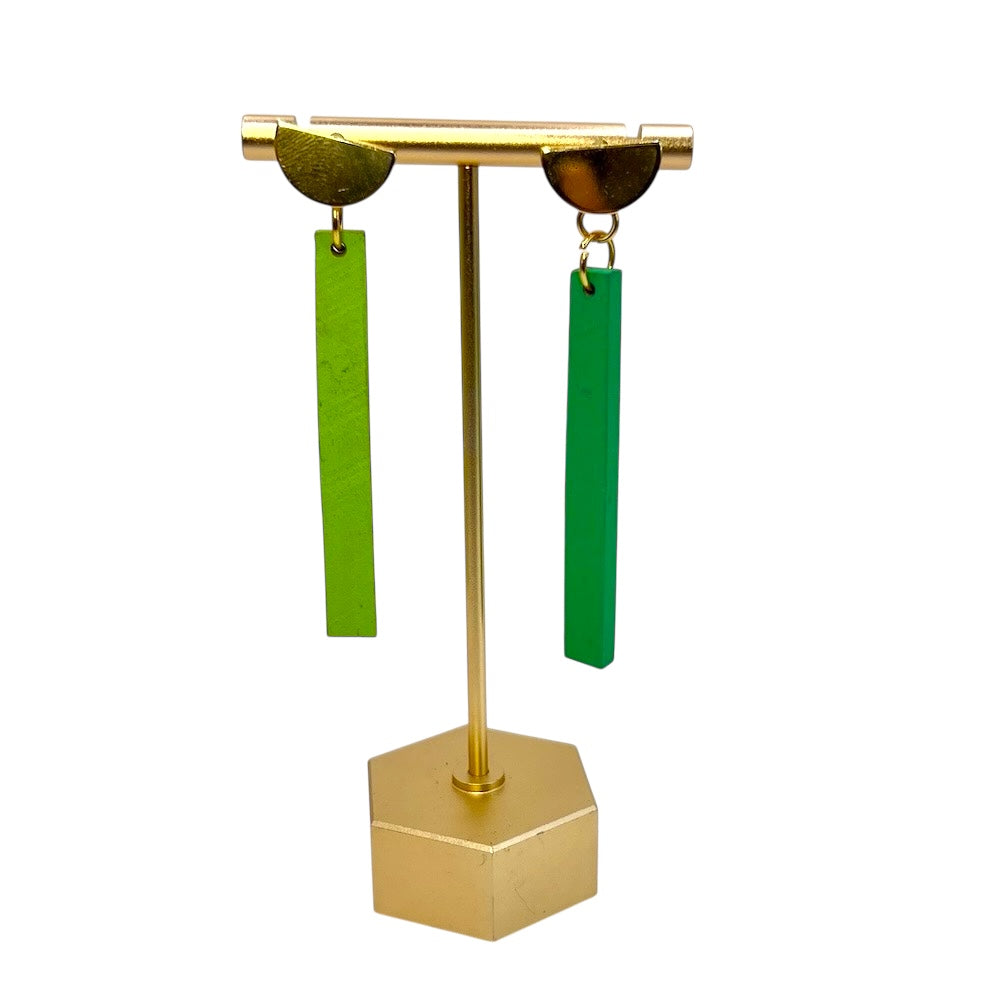 Miss matched painted rectangle earrings one yellow one green hanging from golden 1/2 moon findings