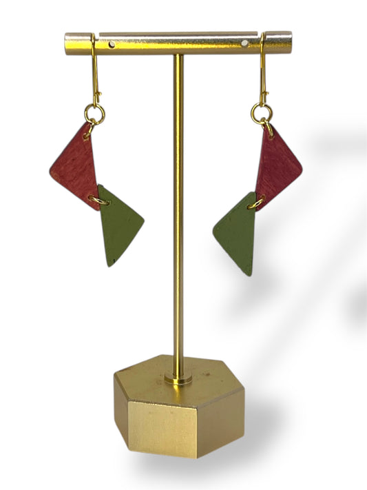 Geometric earrings on a gold stand with a white background
