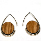 Teardrop-shaped earrings with wooden disc centers on a white background