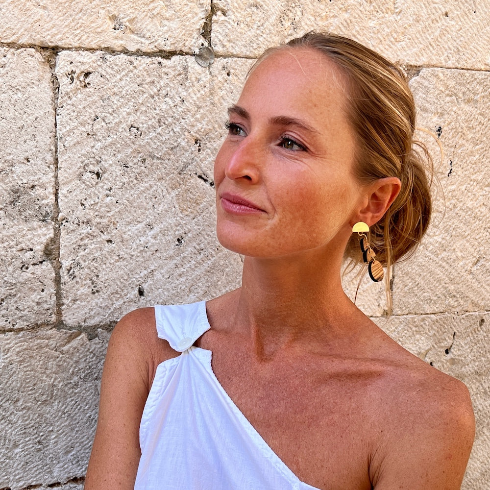 Moon Phase upcycled olive wooden earrings - statemetnt jewerly on model in Croatia, made by Madera Design Studio 