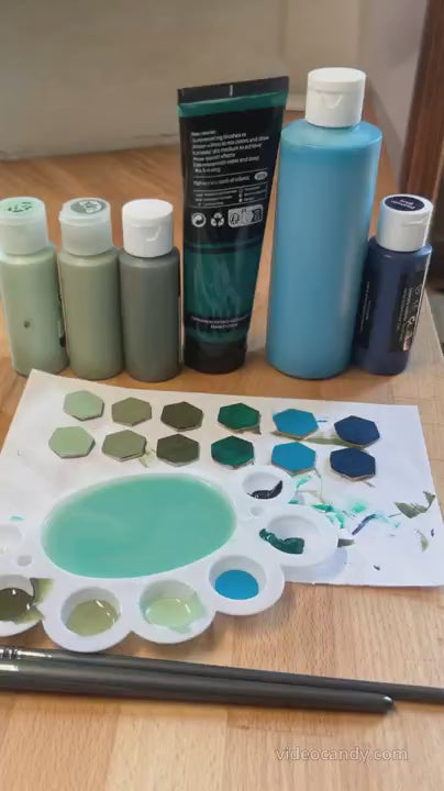 Behinds the scenes video of madera design studio's stacey shevlin showing the shades of blue and green paint that she uses to hand paint these wood threader earrings. 

