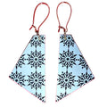 Snowflake earrings on red background by Madera Design Studio