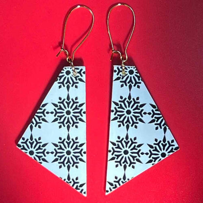 Snowflake earrings on red background by Madera Design Studio