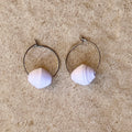 Single paper bead, white paper bead earring on a stone background