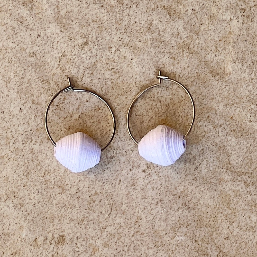 Single paper bead, white paper bead earring on a stone background